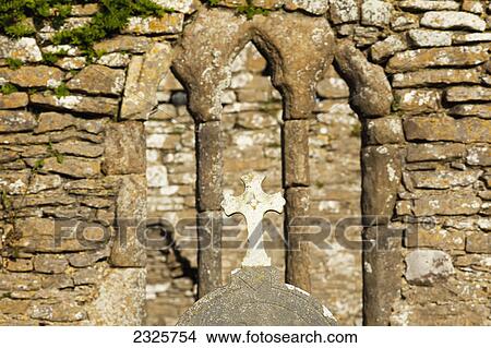 Picture - Stone wall and cross of an old church at hook head; County wexford ireland. Fotosearch