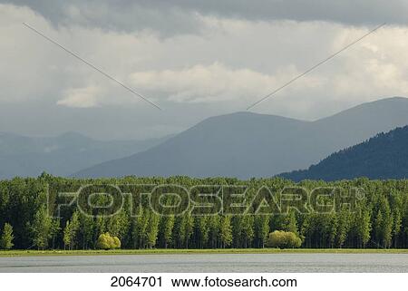 Stock Image - Storm Clouds Over Mountains, Kootenay Lake, Kuskonook, Bc, Canada. Fotosearch