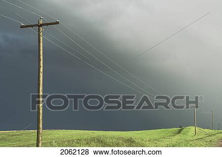 Stock Photo - Stormy Sky And Sunlight On Hydro-Electric Power Lines, Rural Manitoba, Canada. Fotosearch