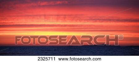 Streaks of orange red and yellow in a glowing sky at sunset over mannin bay near ballyconneely; County galway ireland View Large Photo Image Stock Image - Streaks of orange red and yellow in a glowing sky at sunset over mannin bay near ballyconneely; County galway ireland. Fotosearch