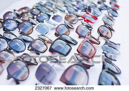 Sunglasses on display in a row; Chiang mai thailand View Large Photo Image Stock Photo - Sunglasses on display in a row; Chiang mai thailand. Fotosearch