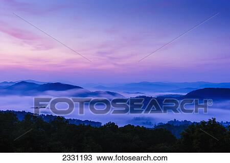 Stock Image - Sunrise as seen from the overlook along the foothills parkway great smoky mountains national park; Tennessee united states of america. Fotosearch