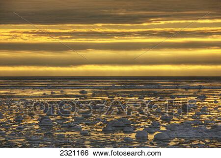 Stock Photograph - Sunrise Over An Ice Filled Bay Of Hudson's Bay; Manitoba Canada. Fotosearch