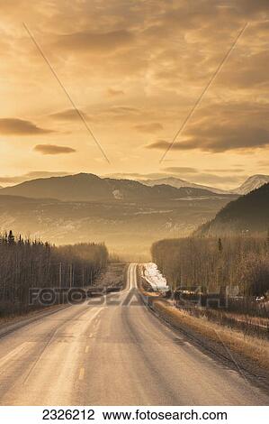 Sunrise over the alaska highway west of fort nelson in the canadian rockies in early spring; British columbia canada View Large Photo Image Stock Image - Sunrise over the alaska highway west of fort nelson in the canadian rockies in early spring; British columbia canada. Fotosearch