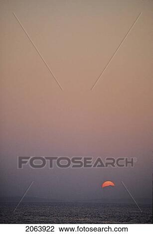 Stock Image - Sunset Is Red Over Mountains Of Vancouver Island, From Water. Fotosearch