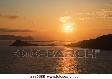 Sunset over the ocean at blasket sound and the blasket islands; County kerry ireland View Large Photo Image Stock Photo - Sunset over the ocean at blasket sound and the blasket islands; County kerry ireland. Fotosearch
