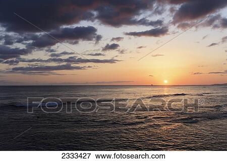Sunset over the pacific ocean; Honolulu hawaii united states of america View Large Photo Image Stock Photo - Sunset over the pacific ocean; Honolulu hawaii united states of america. Fotosearch