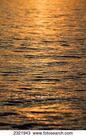 Stock Image - Sunset Reflecting On A Lake; Bardolino Veneto Italy. Fotosearch