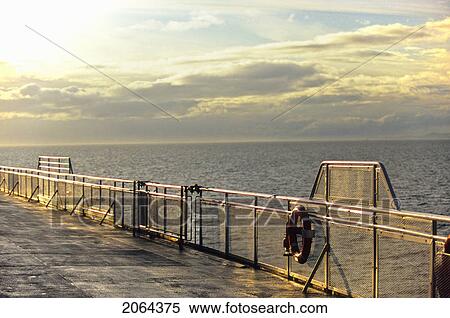 Stock Photography - Sunset Reflection Off The Railing On A Bc Ferry. Fotosearch