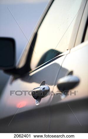 Stock Image - Sunset Reflects Of Door Of Vehicle, Cypress Hills, Saskatchewan, Canada. Fotosearch