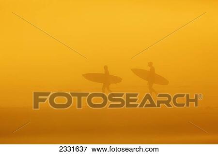 Stock Photo - Surfers in the fog on long beach pacific rim national park; Vancouver island british columbia canada. Fotosearch