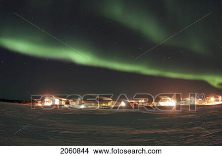 Taken Out On The Popular Ice Road Between Yellowknife And Dettah, Northwest Territories On The Great Slave Lake, This Image Shows Dramatic Aurora Borealis Above The Tiny Dene Hamlet Of Dettah. View Large Photo Image Picture - Taken Out On The Popular Ice Road Between Yellowknife And Dettah, Northwest Territories On The Great Slave Lake, This Image Shows Dramatic Aurora Borealis Above The Tiny Dene Hamlet Of Dettah.. Fotosearch