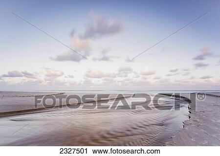Stock Image - Tallows creek running out into the ocean at a spot known as dolphins at tallows beach after heavy storms; Byron bay new south wales australia. Fotosearch
