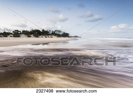 Stock Photo - Tallows creek running out into the ocean at a spot known as dolphins at tallows beach after heavy storms; Byron bay new south wales australia. Fotosearch