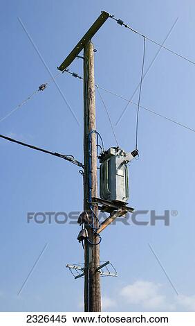 Telephone and electricity cables and post against a blue sky; England View Large Photo Image Stock Photography - Telephone and electricity cables and post against a blue sky; England. Fotosearch