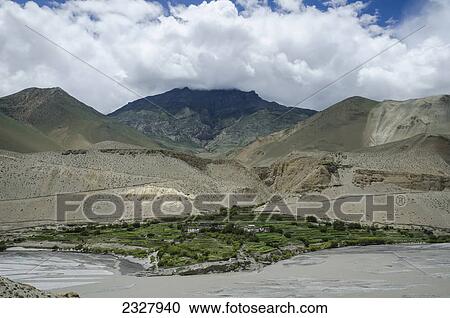 Stock Image - Terraces mountains and clouds near tirigaon village kali gandaki river; Upper mustang nepal. Fotosearch