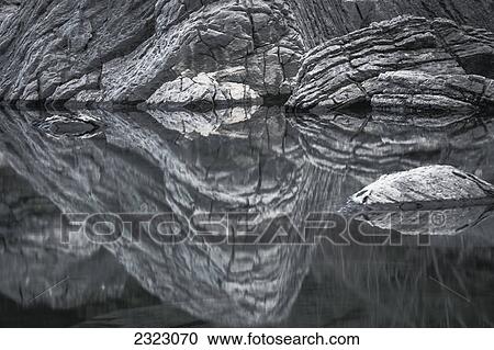 Textured rocks reflected in the calm water of medicine lake jasper national park; Alberta canada View Large Photo Image Stock Image - Textured rocks reflected in the calm water of medicine lake jasper national park; Alberta canada. Fotosearch