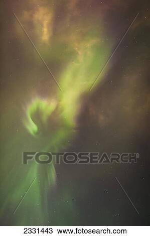 Stock Image - The aurora borealis corona in the sky above the tony knowles coastal trail in winter at nighttime; Anchorage alaska united states of america. Fotosearch