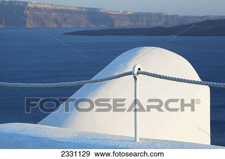Stock Photo - The coastline of the aegean sea; Oia greece. Fotosearch