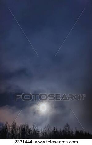 The full moon sets through the fog above the tony knowles coastal trail in winter at nighttime; Anchorage alaska united states of america View Large Photo Image Picture - The full moon sets through the fog above the tony knowles coastal trail in winter at nighttime; Anchorage alaska united states of america. Fotosearch