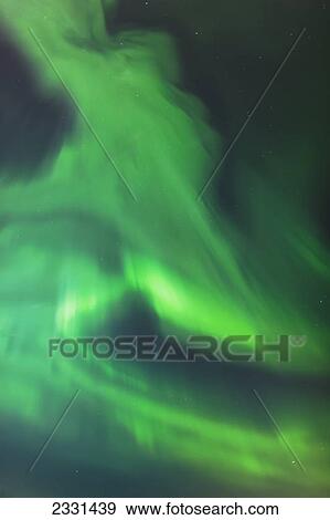The green northern lights corona in the sky above the tony knowles coastal trail in winter at nighttime; Anchorage alaska united states of america View Large Photo Image Stock Photo - The green northern lights corona in the sky above the tony knowles coastal trail in winter at nighttime; Anchorage alaska united states of america. Fotosearch