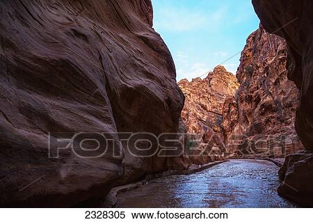 Stock Photography - The high rock walls along the entrance into the ancient city; Petra jordan. Fotosearch