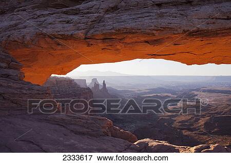The lower arch glows a brilliant orange as the sun rises over mesa arch in canyonlands national park; Moab utah united states of america View Large Photo Image Stock Photo - The lower arch glows a brilliant orange as the sun rises over mesa arch in canyonlands national park; Moab utah united states of america. Fotosearch