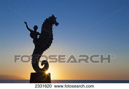 Stock Image - The seahorse sculpture on the malecon at sunset; Puerto vallarta mexico. Fotosearch