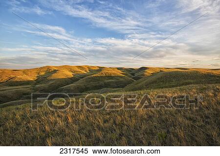 The Setting Sun Lights Up The Top Of The Coulees In Grasslands National Park; Saskatchewan Canada View Large Photo Image Stock Photography - The Setting Sun Lights Up The Top Of The Coulees In Grasslands National Park; Saskatchewan Canada. Fotosearch