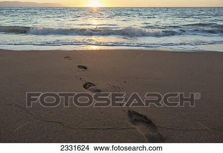 Picture - The sun sets in the distance in banderas bay; Puerto vallarta mexico. Fotosearch