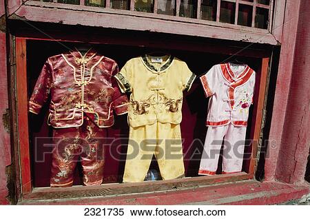 Stock Photography - Three Children's Outfits In A Display Case In An Open Window; Forbidden City Beijing China. Fotosearch