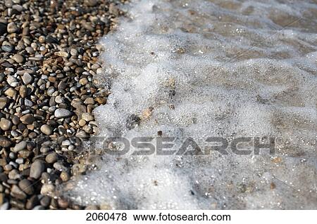 Stock Photo - Tide Washing Over Pebbles, Ontario. Fotosearch