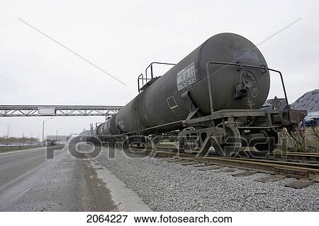 Stock Photo - Train Alongside Empty Road In Industrial Setting, Hamilton, Ontario.. Fotosearch