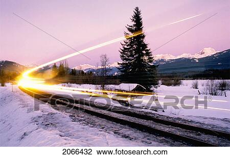 Train Light Shows Speed Along Winter Train Tracks, Alpenglow Behind, Whistler, Bc View Large Photo Image Stock Image - Train Light Shows Speed Along Winter Train Tracks, Alpenglow Behind, Whistler, Bc. Fotosearch