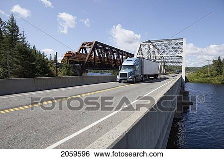 Transport Truck And Freight Train Crossing Spanish River Near Espanola Ontario View Large Photo Image Stock Photograph - Transport Truck And Freight Train Crossing Spanish River Near Espanola Ontario. Fotosearch