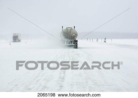 Transport Trucks Make Their Way Across The Mackenzie River Ice Crossing (Which Is Serviced By A Ferry In The Summer Months) Just Outside Fort Providence, Northwest Territories. View Large Photo Image Stock Photo - Transport Trucks Make Their Way Across The Mackenzie River Ice Crossing (Which Is Serviced By A Ferry In The Summer Months) Just Outside Fort Providence, Northwest Territories.. Fotosearch