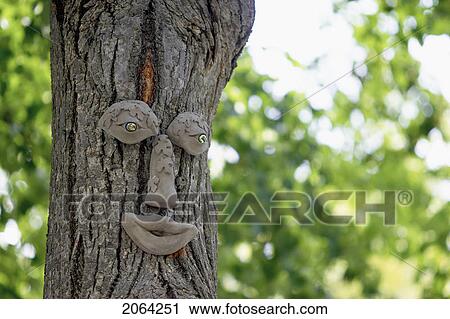 Stock Image - Tree Trunk With Eyes, Nose, And Mouth, Burlington, Ontario.. Fotosearch