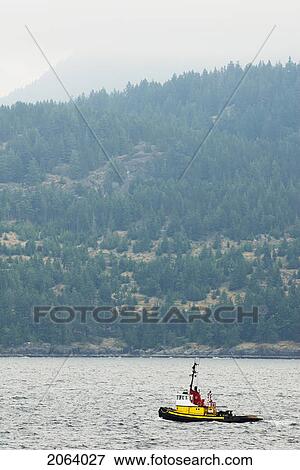 Tug Boat In The Ocean With Mountains In The Background, Howe Sound, Bc View Large Photo Image Stock Photo - Tug Boat In The Ocean With Mountains In The Background, Howe Sound, Bc. Fotosearch