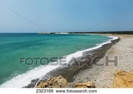 Turquoise ocean water coming into shore along a beach; Akamas peninsula cyprus View Large Photo Image Stock Photo - Turquoise ocean water coming into shore along a beach; Akamas peninsula cyprus. Fotosearch