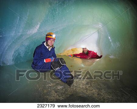 Two female cavers exploring a cave ice-plug; Crowsnest pass alberta canada View Large Photo Image Stock Photo - Two female cavers exploring a cave ice-plug; Crowsnest pass alberta canada. Fotosearch