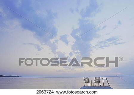 Picture - Two Folding Lawn Chairs On Dock At Clear Lake; Canada, Manitoba, Riding Mountain National Park. Fotosearch