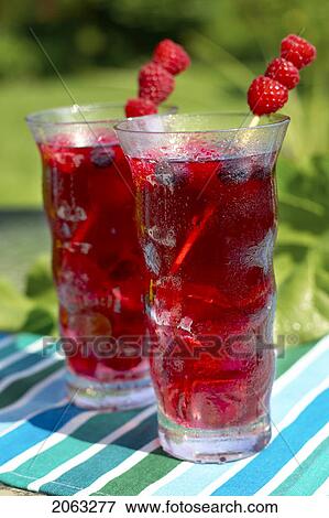 Stock Photo - Two Glasses Of Fruit Juice Garnished With Raspberries, Canada, Ontario. Fotosearch