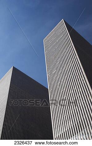 Two skyscrapers against a blue sky; New york city new york united states of america View Large Photo Image Stock Photo - Two skyscrapers against a blue sky; New york city new york united states of america. Fotosearch