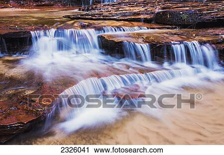 Stock Image - Utah, Zion National Park, Archangel Falls along the Subway Trail.. Fotosearch