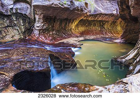 Stock Photo - Utah, Zion National Park, Subway Slot Canyon, Stunning cavern and pool of water.. Fotosearch
