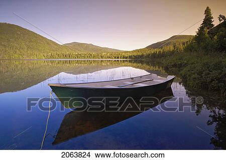 View Of Boat At Lebreux Lake At Sunset, Quebec View Large Photo Image Picture - View Of Boat At Lebreux Lake At Sunset, Quebec. Fotosearch