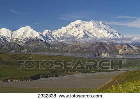 Stock Photo - View of Mt. McKinley on a sunny day across the Thorofare River, Denali National Park and Preserve, Interior Alaska, summer. Fotosearch