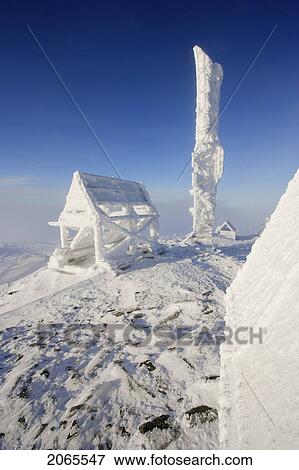 Stock Photo - View Of Snow-Covered Shelter At Top Of Mont Logan At Sunrise, Quebec, Canada. Fotosearch
