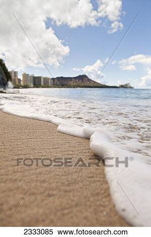 View of waves coming onto the shore of waikiki beach with diamond head in the distance; Waikiki oahu hawaii united states of america View Large Photo Image Stock Photography - View of waves coming onto the shore of waikiki beach with diamond head in the distance; Waikiki oahu hawaii united states of america. Fotosearch