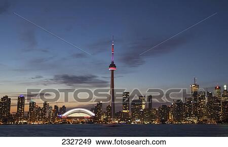 View over lake ontario of the downtown toronto skyline and cn tower illuminated at dusk; Toronto ontario canada View Large Photo Image Stock Photo - View over lake ontario of the downtown toronto skyline and cn tower illuminated at dusk; Toronto ontario canada. Fotosearch